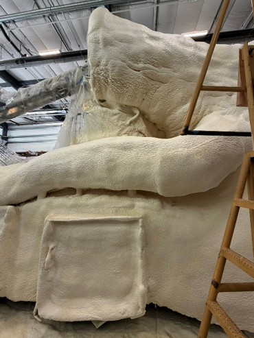Behind-the-scenes view of certified applicators spraying closed cell foam with Solstice LBA onto the Jungle Jumpstart Rose Parade float structure
