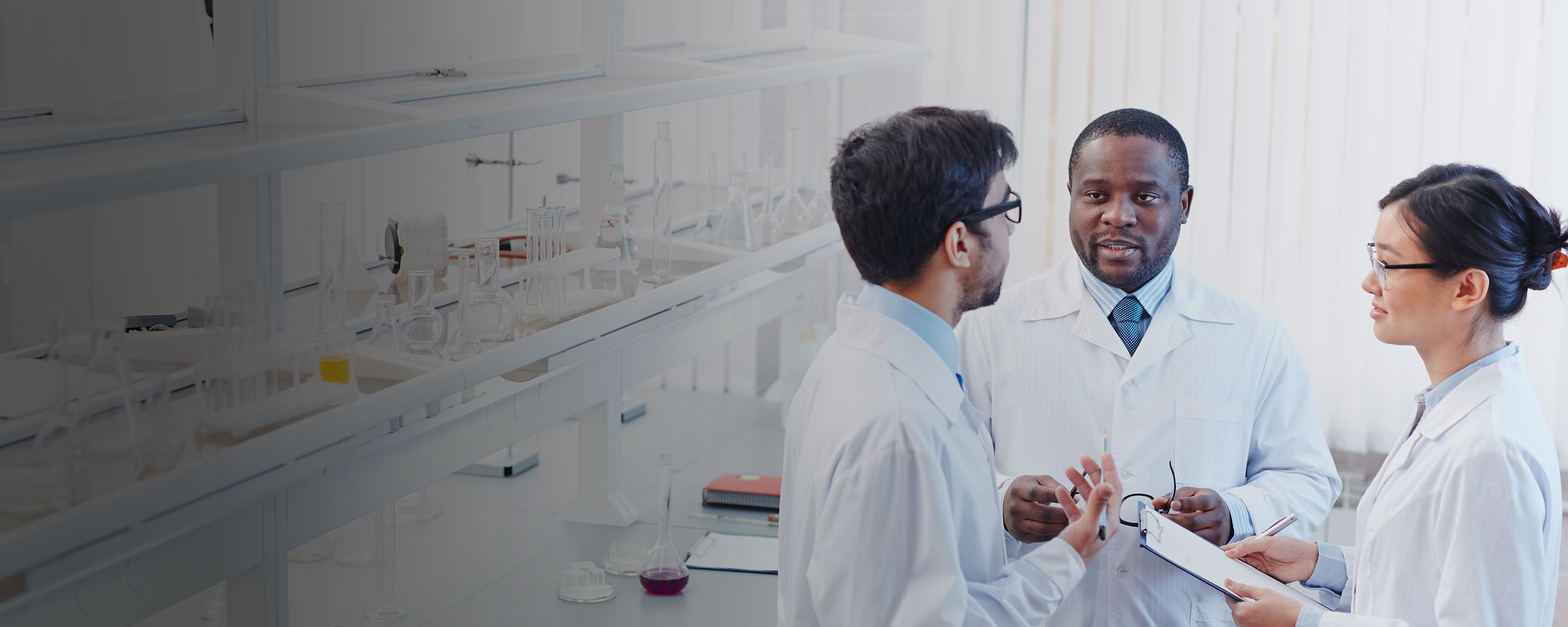 Three scientists gathered in an office